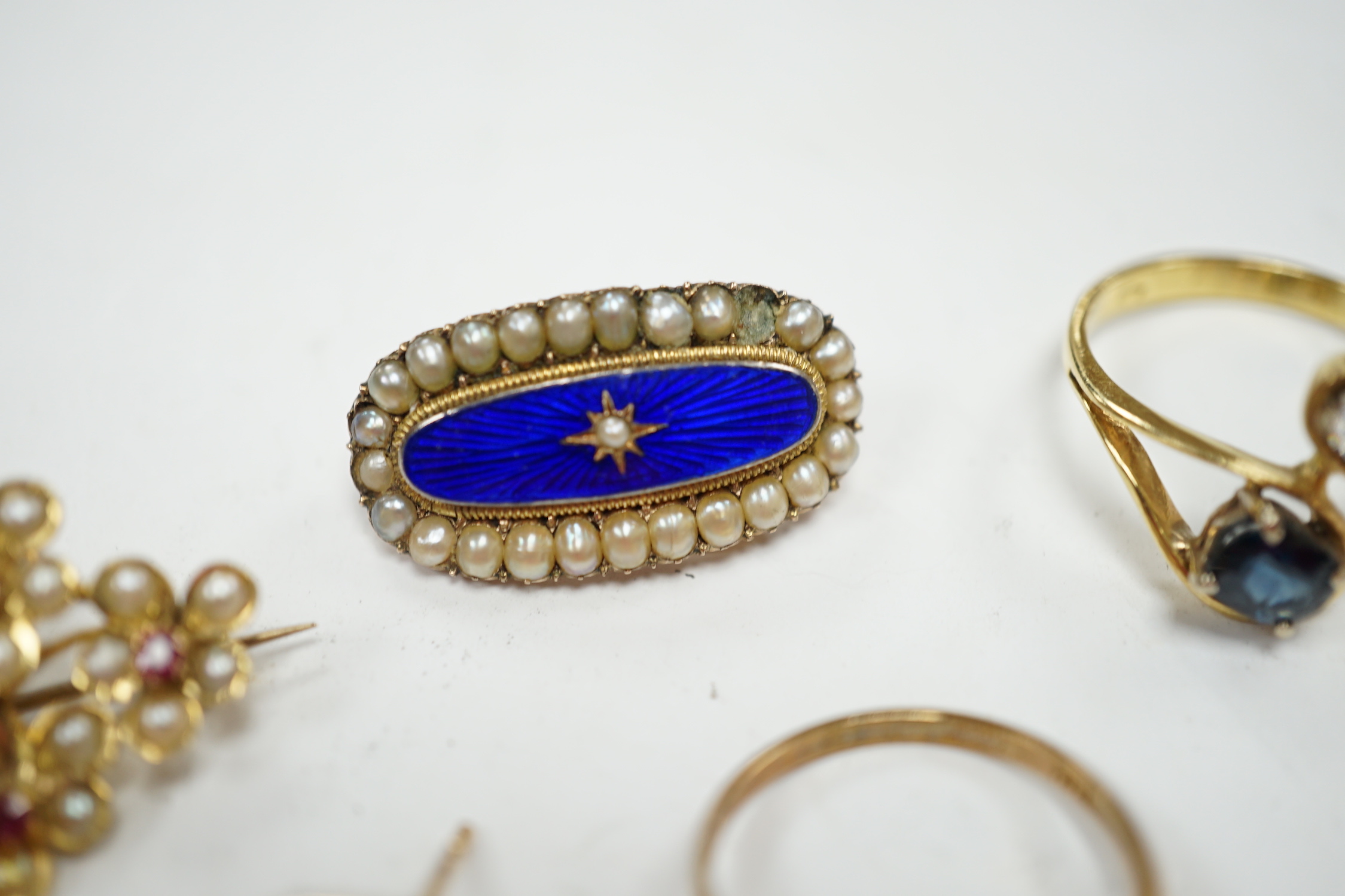 A 750 yellow metal, single stone sapphire and three stone diamond set crossover ring, size, three other yellow metal and gem set rings including a continental 875 white metal and 585 yellow metal, synthetic sapphire or s